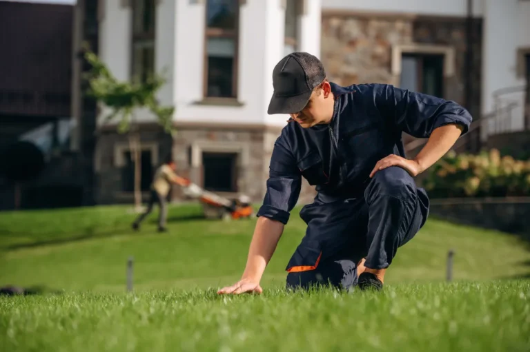 A service worker guy checking the grass height.